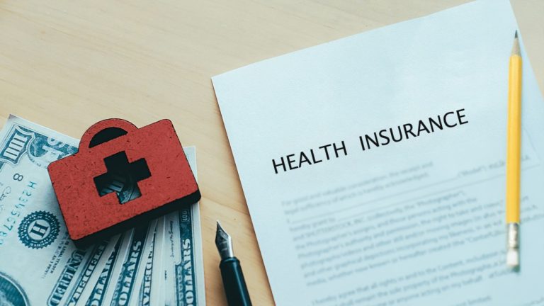 Small business owner reviewing group insurance policy options with Synergy Insurance advisor in India